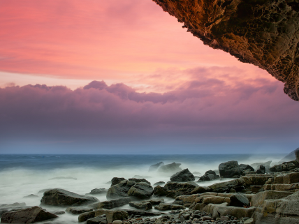 Rocks inside the sea and clouds in the sky