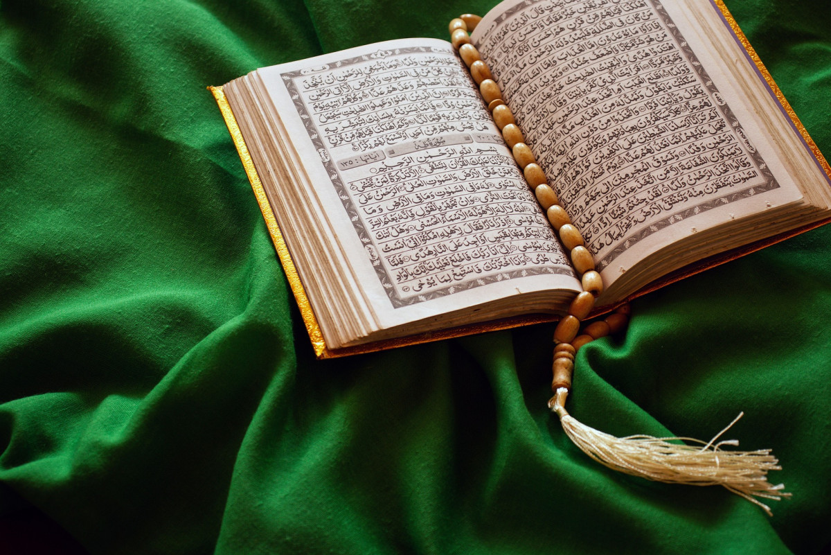 The book of God on a green silk top